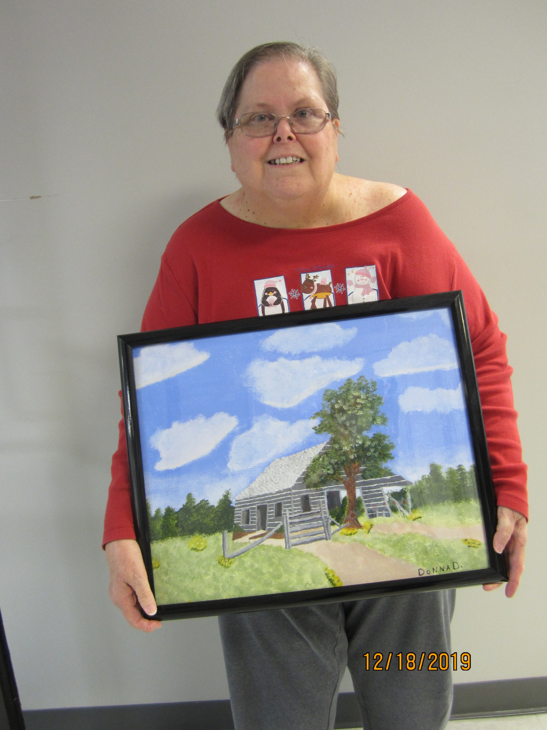 Woman holding her painting