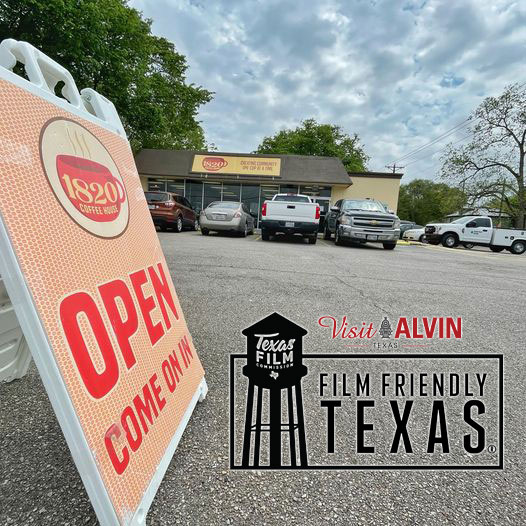 open sign out front of 1820 coffee with Film friendly texas logo
